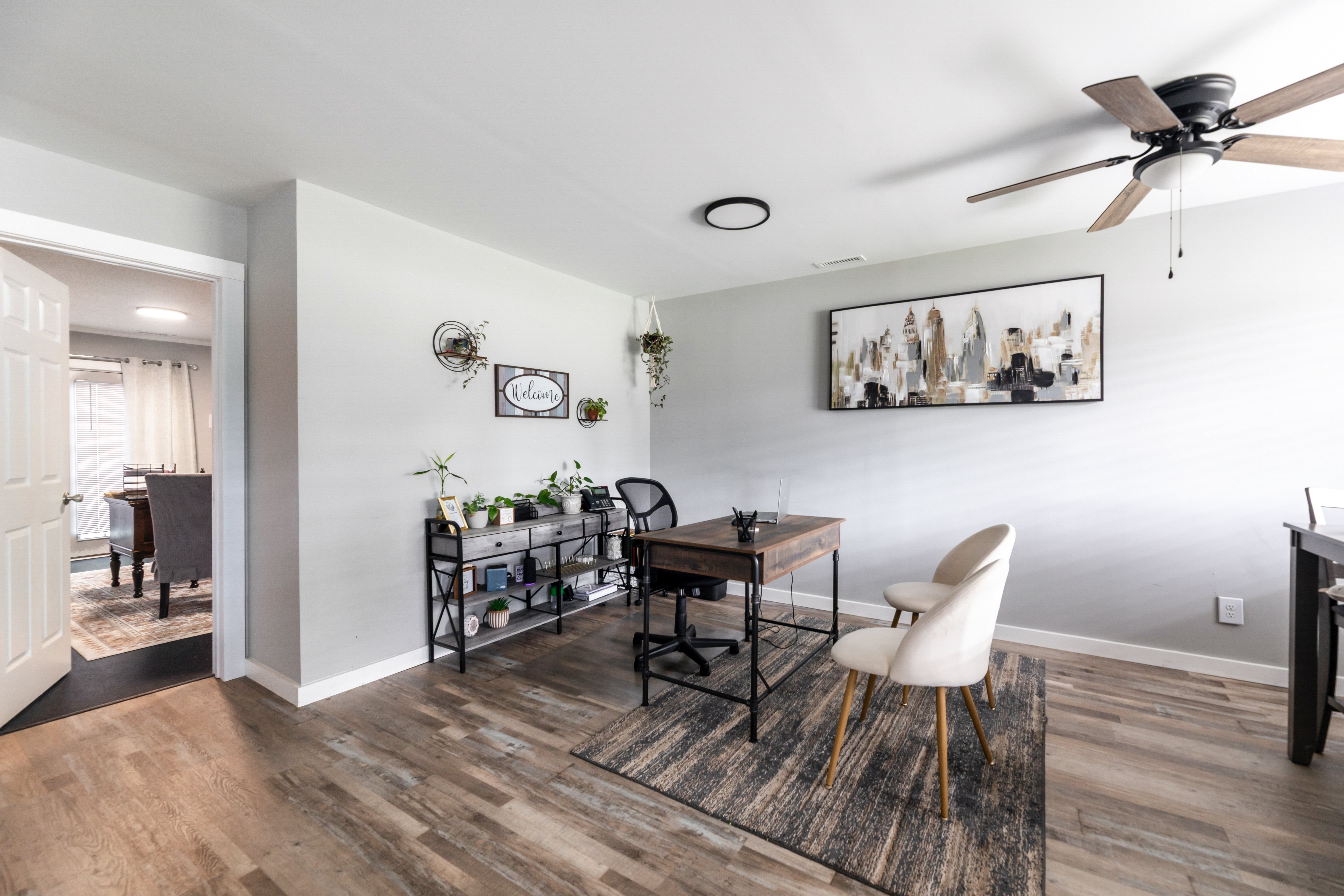A room with a ceiling fan and a table with chairs.at Lauradale, Jacksonville, NC 28540